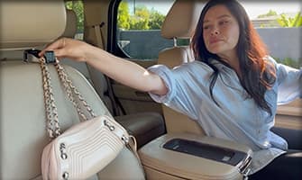 Woman hanging purse from Car Hooker